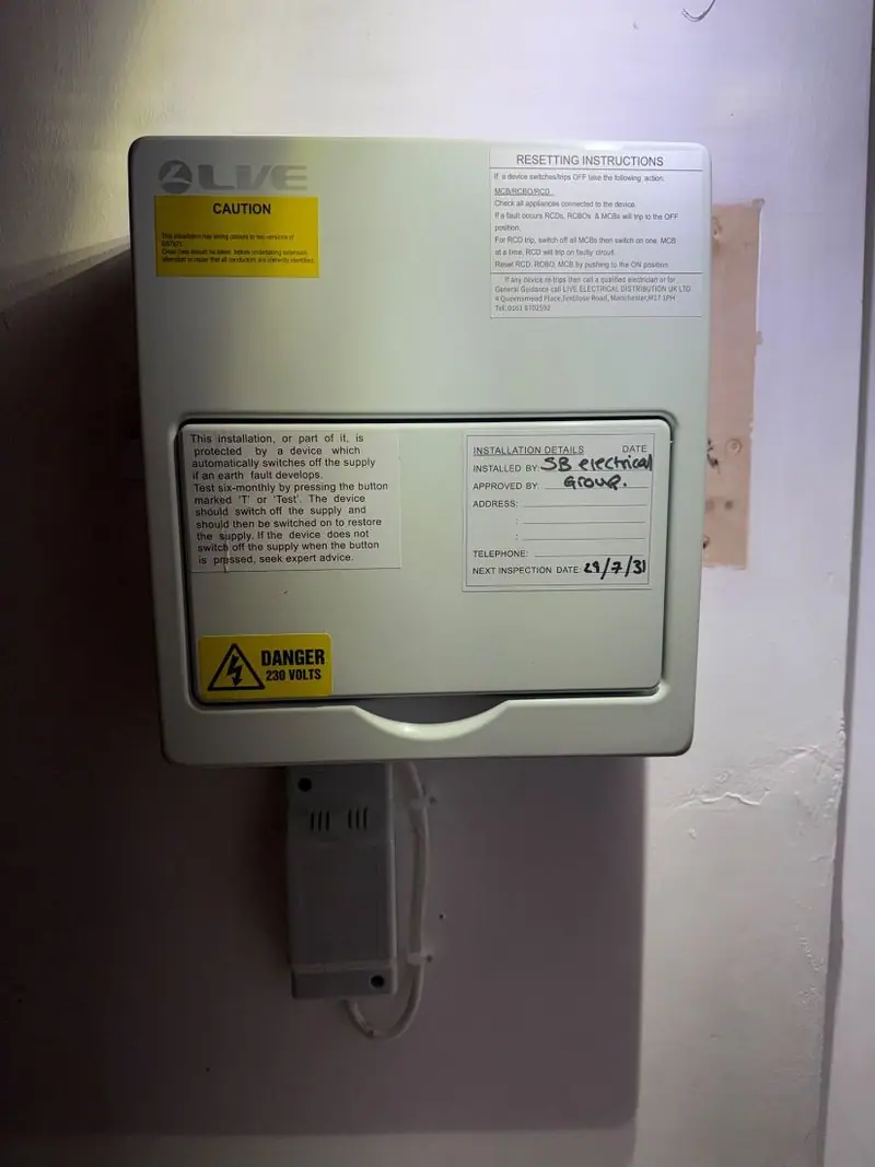 Labelled consumer unit after EICR remedial work in a social home